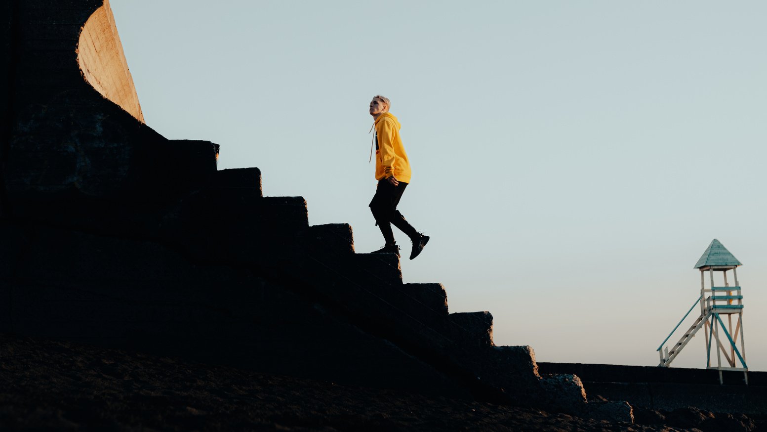 A Young Man in a Trendy Outfit Walking up the Stairs